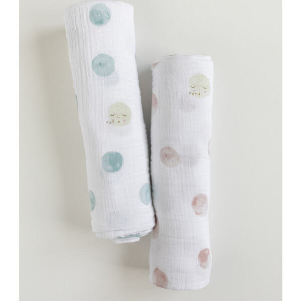 Pehr muslin swaddles in luna dot blue and luna dot pink rolled up next to each other