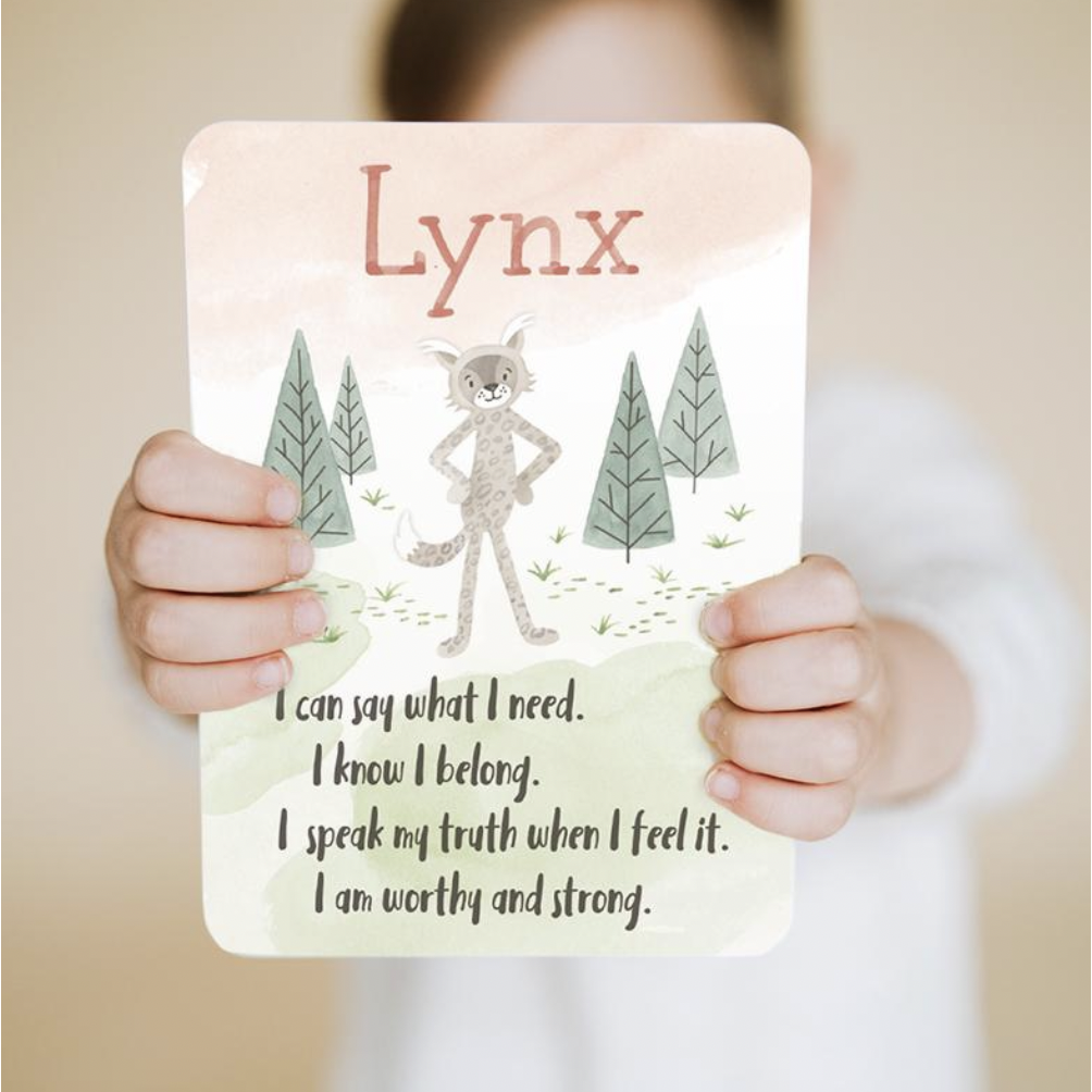 childs hands holding slumberkins lynx affirmation card