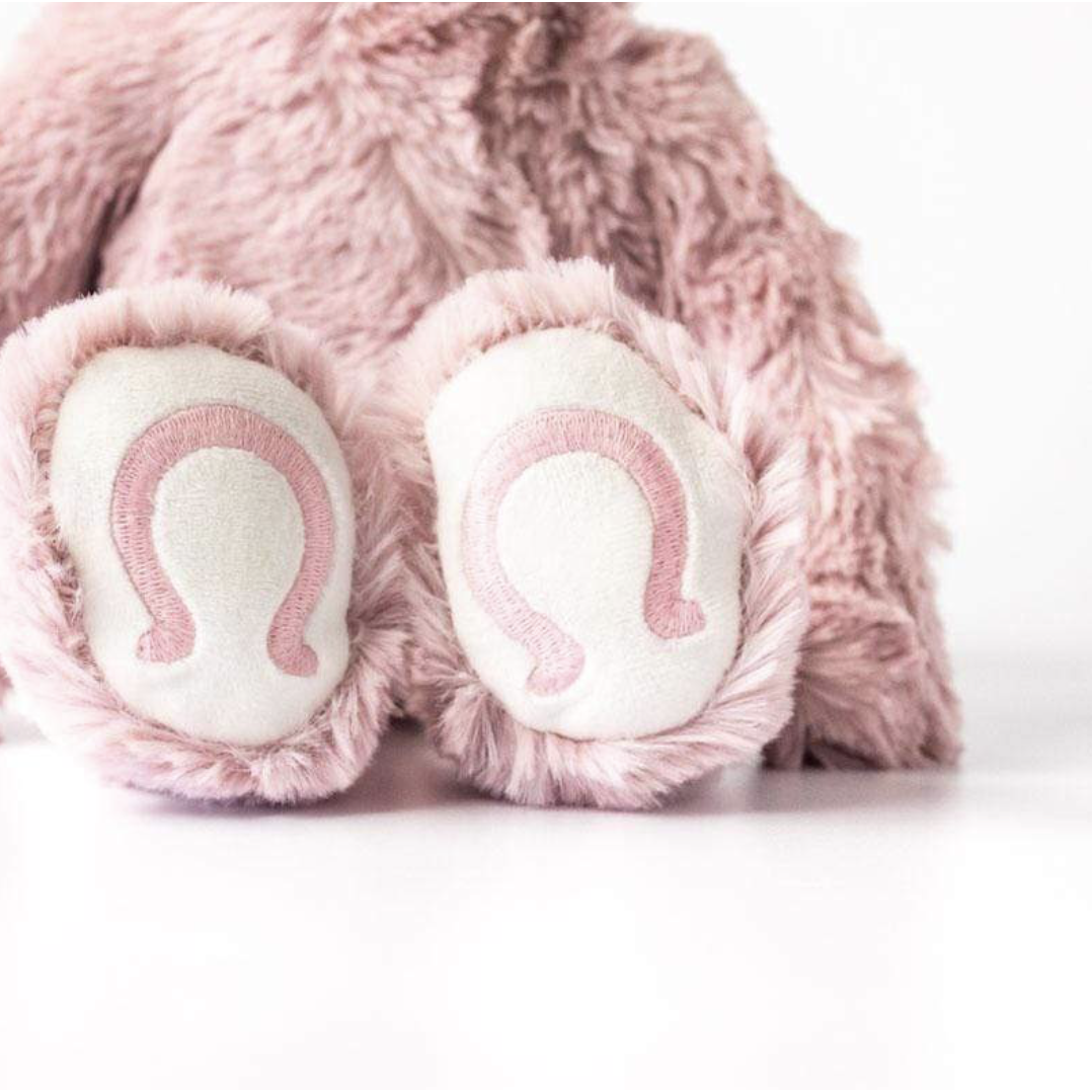 close up of slumberkins pink unicorn kin feet