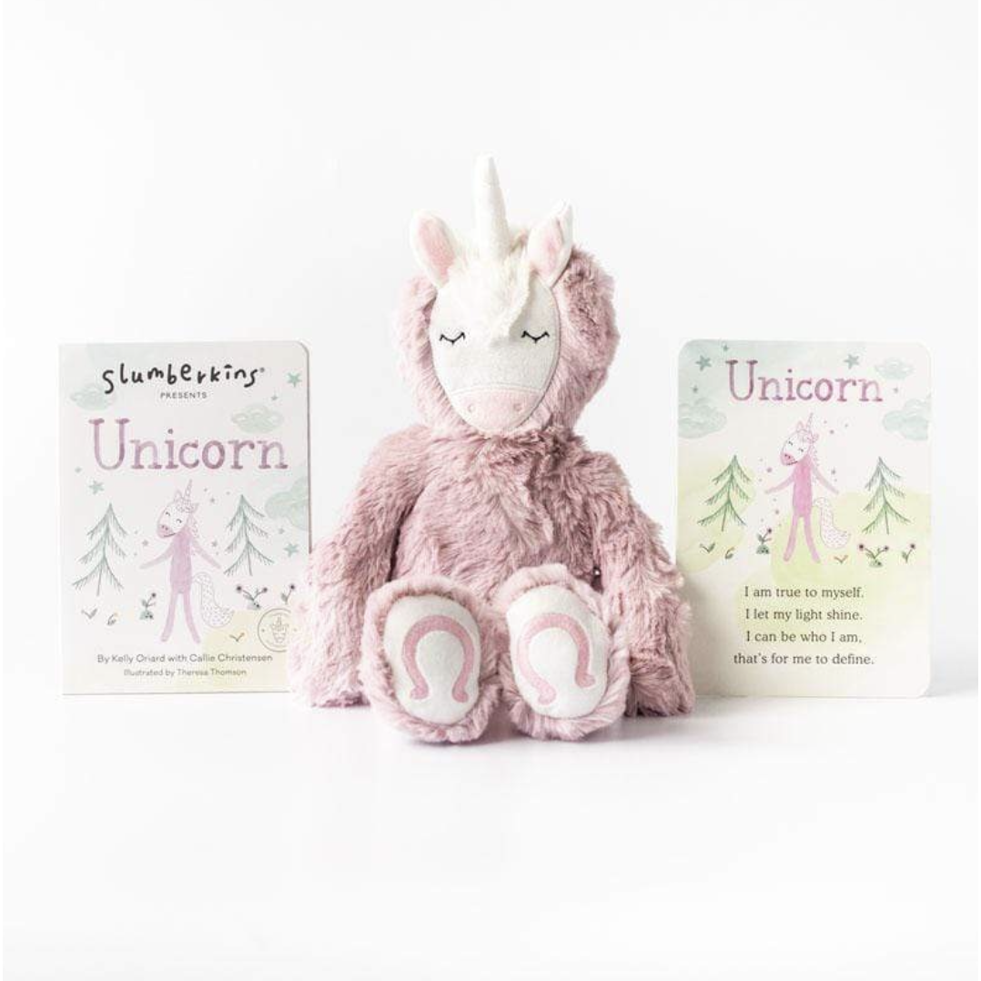slumberkins pink unicorn kin sitting with board book and affirmation card